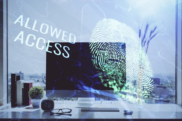 computer on desktop in office with finger print drawing double exposure concept of business data security