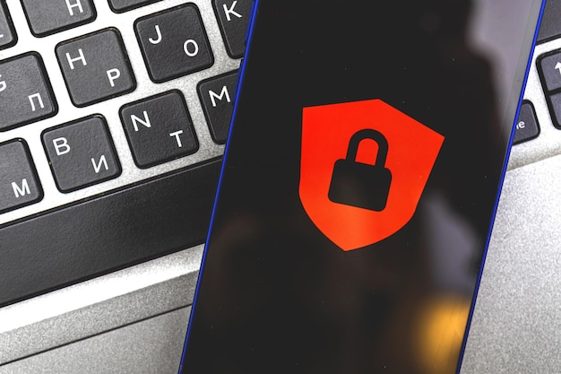 Concept of access denied, personal data protection and security, background of a smartphone with red lock and laptop