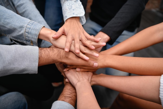 Cropped image of people stacking hands