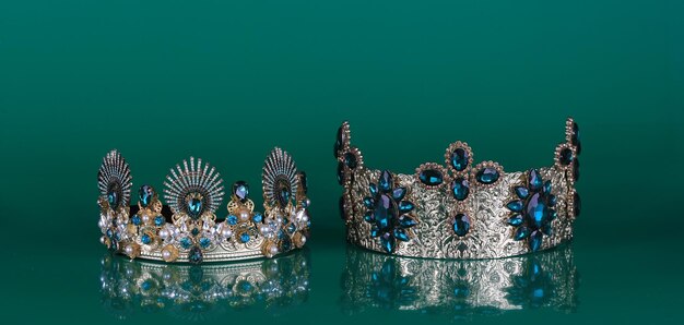 crown with precious stones isolated on green background