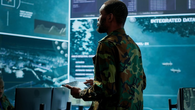 cybersecurity specialist operates in a high tech military control center