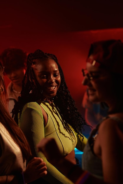 Dancing among happy people in club