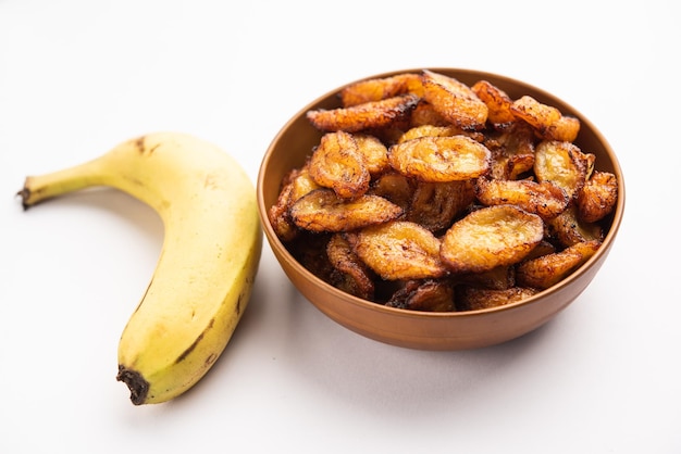 Deep fried ripe plantain slices or pake kele fried chips in a bowl