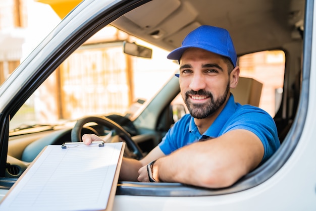 delivery man giving clipboard to customer for signature