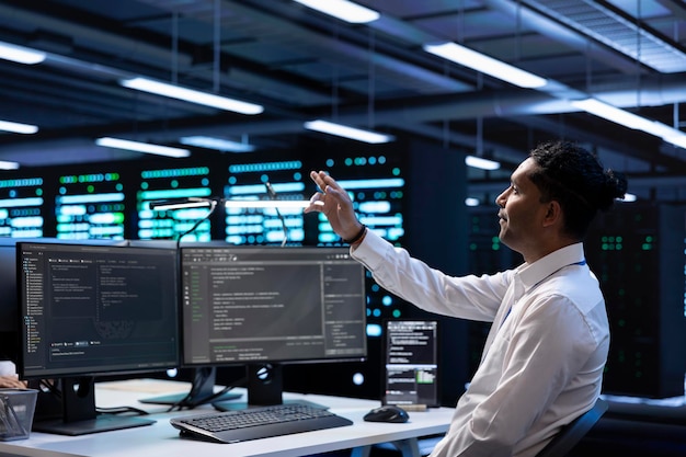 developer looking at holograms in data center monitoring infrastructure