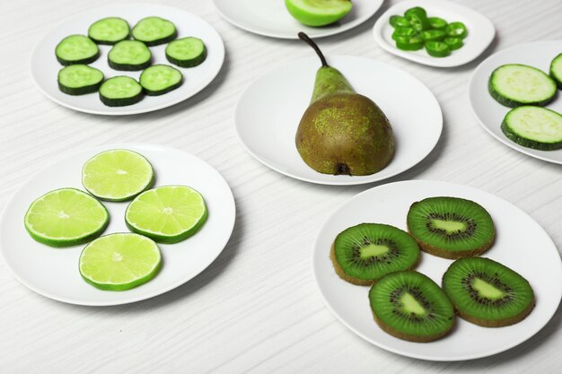 Different products on saucers on wooden table close up