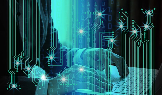 digital composite image of businessman using laptop with binary codes