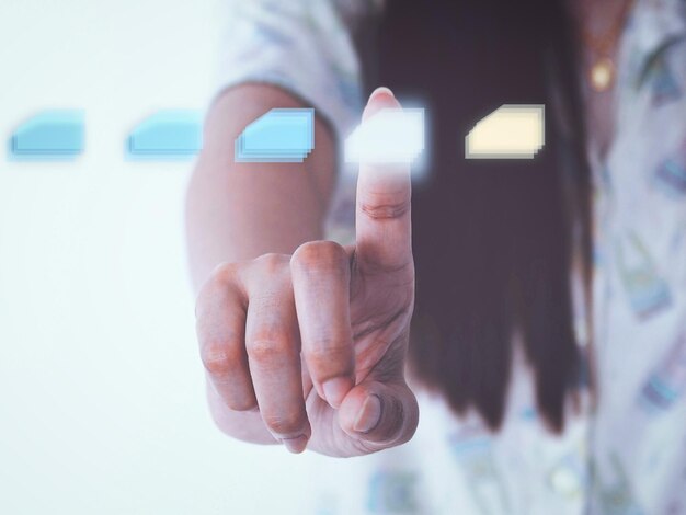 digital composite image of woman touching button on invisible screen with icon