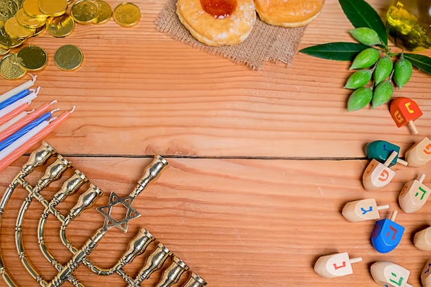 Directly above shot of dreidel with menorah and food on table
