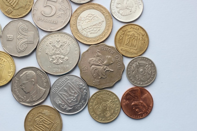 Directly above shot of various coins against white background