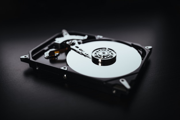 disassembled hard drive from the computer, hdd with mirror effects. part of computer pc, laptop