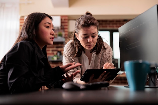 diverse programming engineers analyzing html code on computer, planning artificial intelligence project. web developers working on machine learning software, developing new interface.