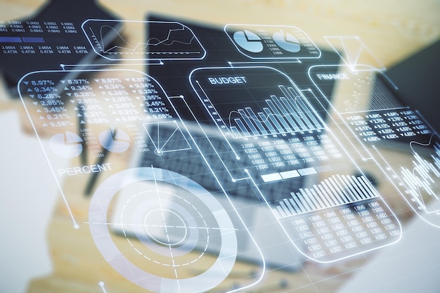 Double exposure of abstract creative statistics data hologram on laptop background statistics and analytics concept