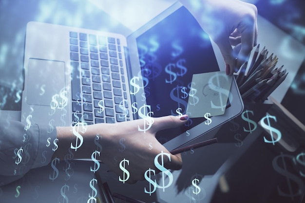 Double exposure of businesswoman hands typing on computer and financial graph hologram drawing Stock market analysis concept