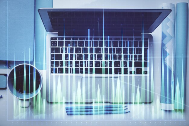 Double exposure of forex graph drawing over desktop background with computer Concept of financial analysis Top view