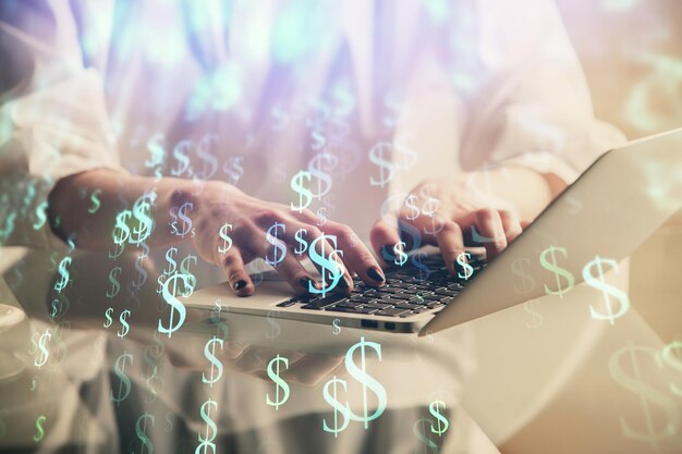 Double exposure of woman hands typing on computer and forex chart hologram drawing Stock market invest concept