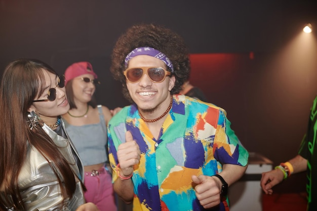 Dynamic couple dancing together in club