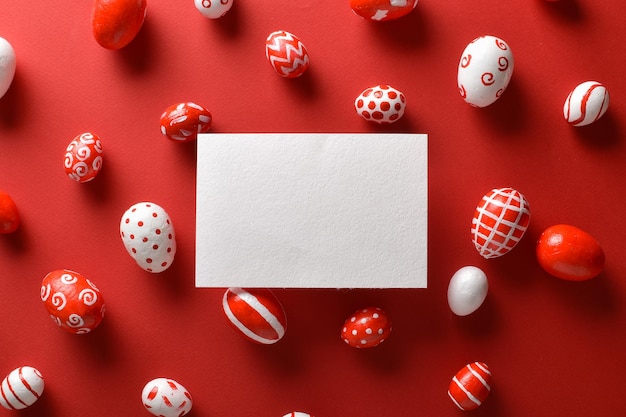 Easter banner with a blank sheet of paper and Easter red and white eggs on a bright red background