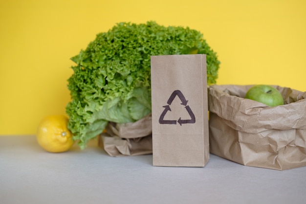 Eco friendly packaging for foods with vegetables on yellow background