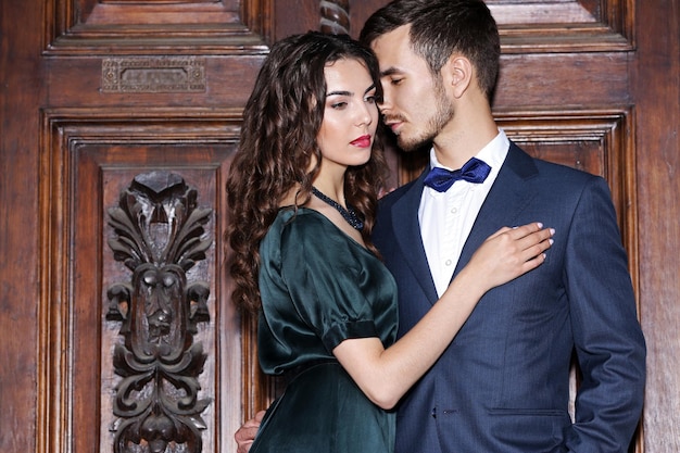 elegant couple on old wooden door background