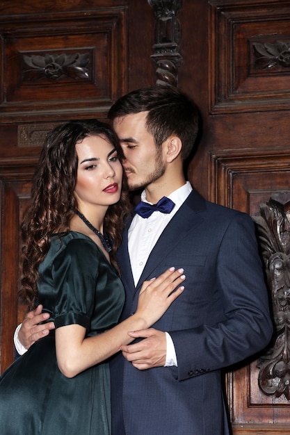 elegant couple on old wooden door background