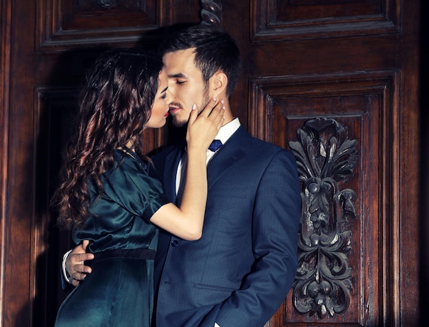 elegant couple on old wooden door background