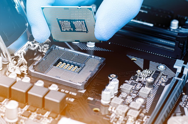 Engineer technician installs computer microprocessor to motherboard