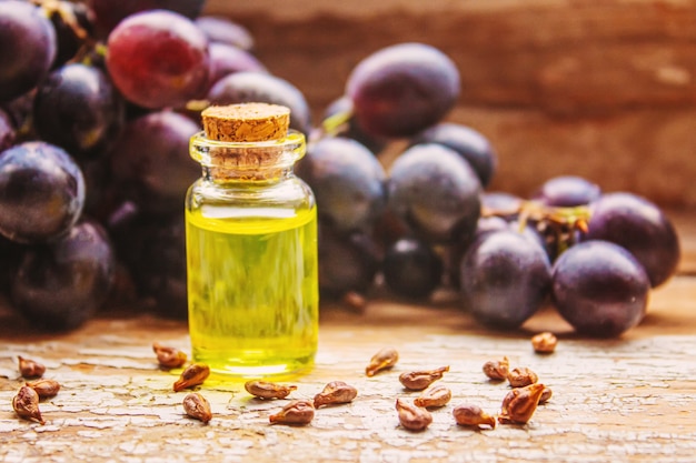 Extract of grape oil in a small jar. Selective focus. food.nature