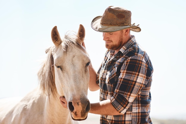 Farmer man and horse outdoor with agriculture for sustainability animal livestock and pet care Equestrian farm owner and entrepreneur with stallion in countryside for recreation riding and hobby