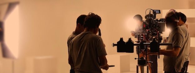 Filmmaker crew team with professional cinema equipment and video camera on the set