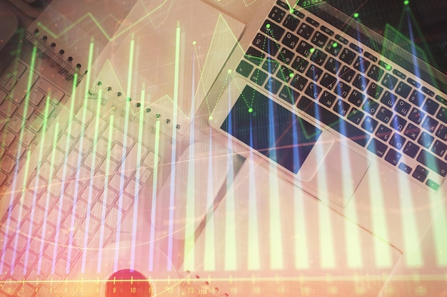 financial market graph and top view computer on the desktop background multi exposure investment concept