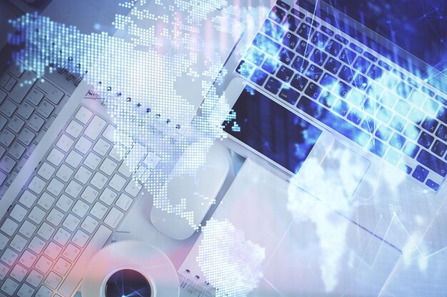 Financial market graph and top view computer on the desktop background Multi exposure Investment concept
