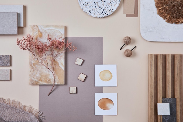 flat lay of stylish architect moodboard composition with beige samples of textile paint wooden lamella panels and tiles top view copy space template
