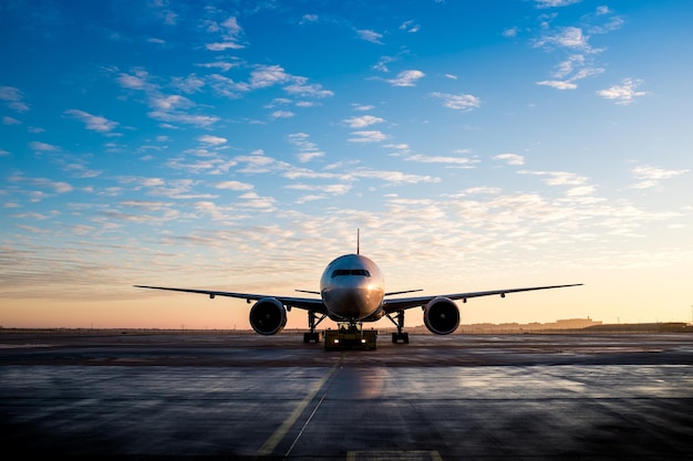 Fly på flyplassens rullebane mot himmelen under solnedgang