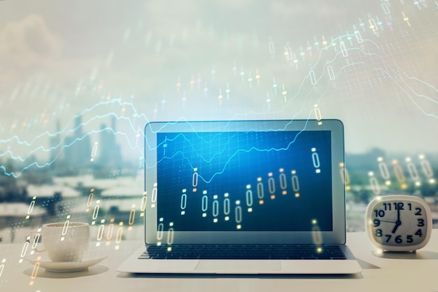 Forex graph hologram on table with computer background Multi exposure Concept of financial markets