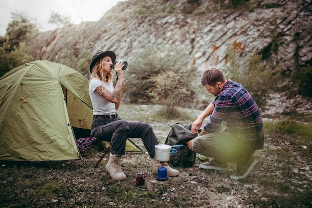 Friends by tent on field
