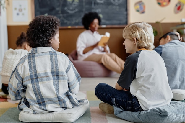 Friends talking during primary school literature class