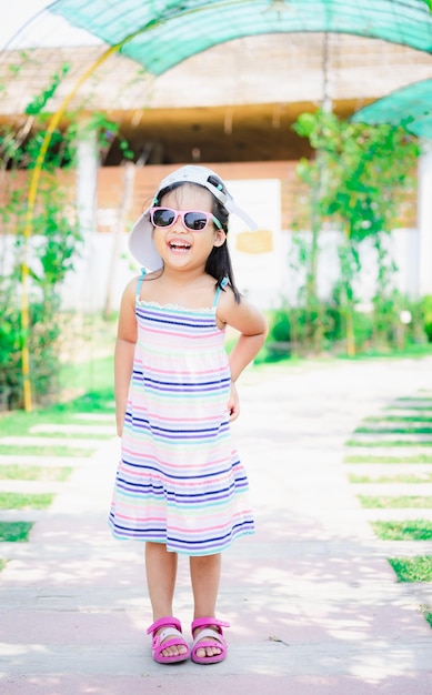 Full length of cute girl wearing sunglasses standing outdoors