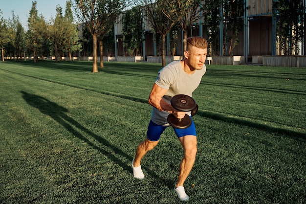 Full length of young man exercising on field