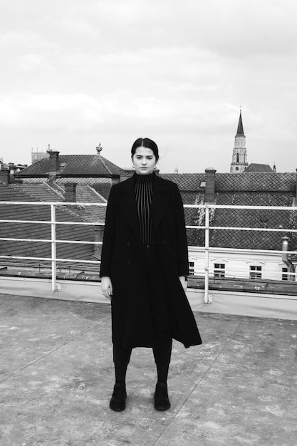 full length portrait of woman standing on terrace against sky