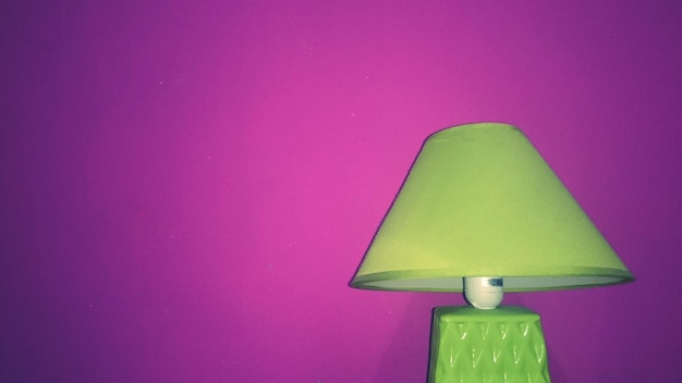 Green lamp against pink wall