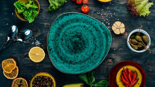 Green plate on a wooden background with vegetables On a wooden table Top view Copy space