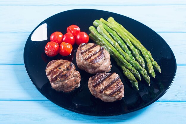 grilled filet mignon with asparagus and tomatoes beef sreak on rustic background