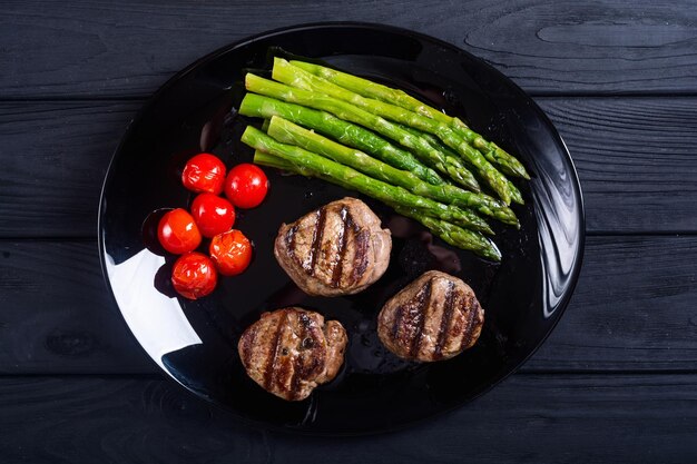 grilled filet mignon with asparagus and tomatoes beef sreak on rustic background