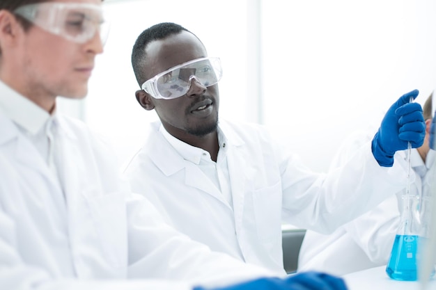 Group of scientists using a computer to enter data