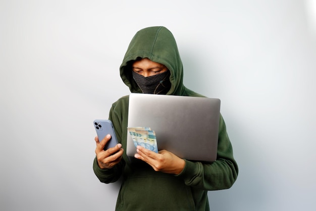 hacker using laptop to steal personal data from people and calling someone to request a ransom
