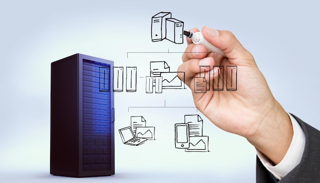 hand holding a marker against digitally generated black server tower