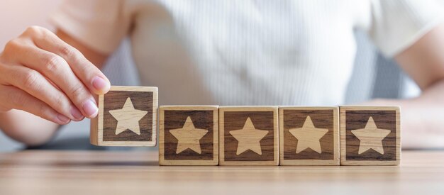 hand holding star block customer choose rating for user reviews quality service rating ranking customer review satisfaction evaluation and feedback concept