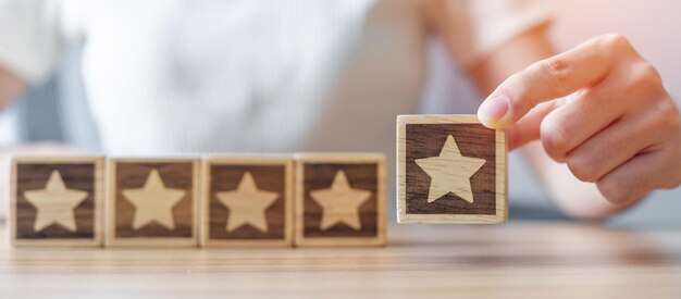 hand holding star block customer choose rating for user reviews quality service rating ranking customer review satisfaction evaluation and feedback concept