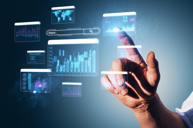 Hand interacting with digital financial charts and graphs on a futuristic touch screen interface in a business and technology concept